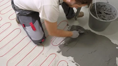 Construction worker preparing tile surface, mixing mortar substrate for flooring Stock Footage 328609287