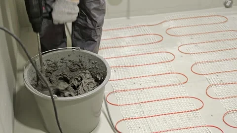 Construction worker preparing tile surface, mixing mortar substrate for flooring Stock Footage 333471164