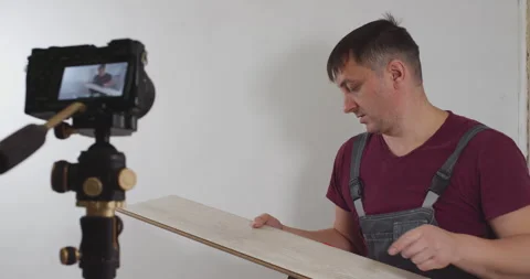 Construction worker presenting laminate flooring to camera Stock Footage 295201296