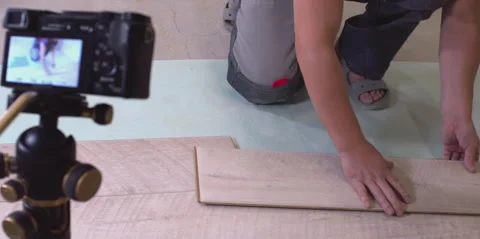 Construction worker presenting laminate flooring sample Stock Footage 298331915