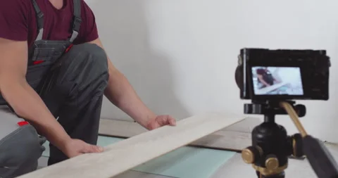 Construction worker presenting laminate flooring sample Stock Footage 298344077
