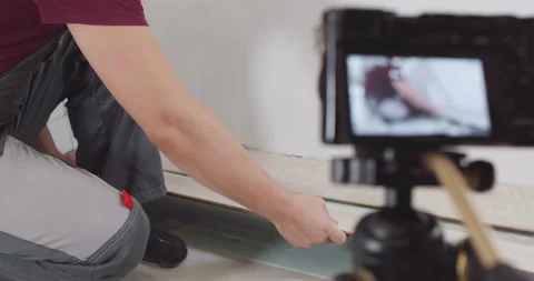 Construction worker presenting laminate flooring sample Stock Footage 303708482