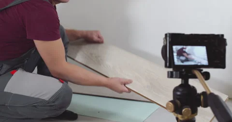 Construction worker presenting laminate flooring sample Stock Footage 303710979