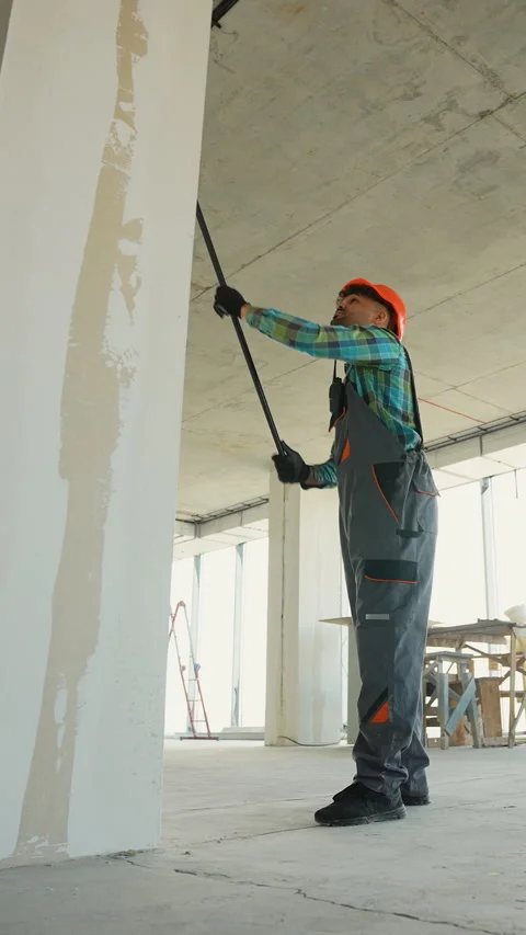 Construction worker priming walls in new building Stock-Footage 312846292