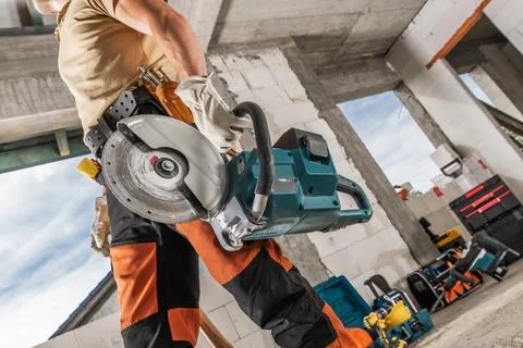 Construction Worker with a Professional Circular Saw in His Hand 库存照片