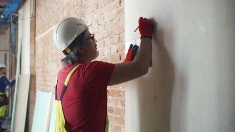 Construction worker in protective helmet and glasses writes in notebook Stock Footage 133637586