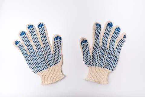 Construction worker protective knitted dotted gloves on white background, han Stock Photos