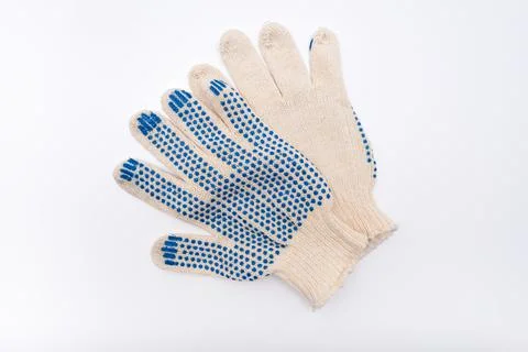 Construction worker protective knitted dotted gloves on white background, hand Stock Photos