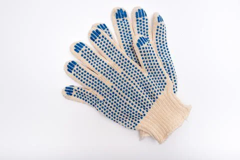 Construction worker protective knitted dotted gloves on white background, hand Stock Photos