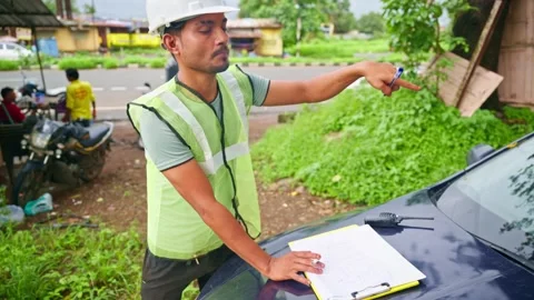 Construction worker puffing inspects area also takes notes Stock Footage 297601403