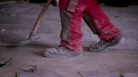 Construction worker pulling out old flooring for replacement. Renovation Stock Footage 111939319