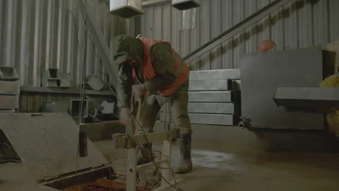 Construction worker pulls bucket with soil from well in shop Stock Footage 255558288