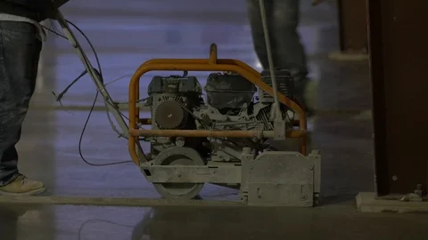 Construction Worker Pushing a Concrete Saw up to a Column Stock Footage 101390343