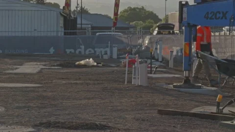 Construction worker pushing wheelbarrow on a construction site Stock Footage 234315622