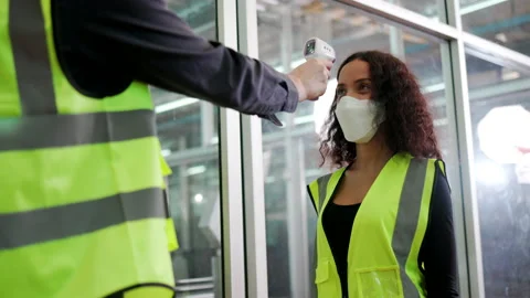 Construction worker put on face mask and Face Shield used body temperature Stock Footage 146823410
