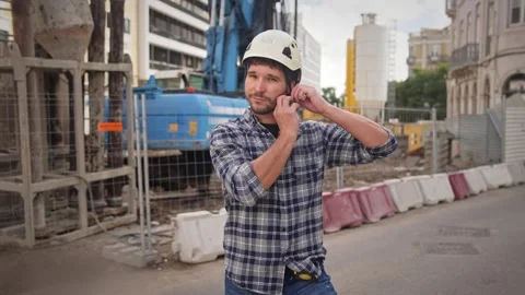 Construction worker put on helmet. Engineer builder portrait. Constructor man. Stock Footage 271223349