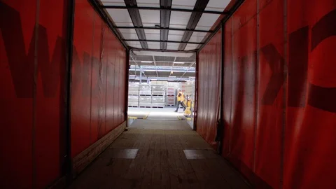 Construction Worker Putting A Pallet Inside Of A Truck Video stock 129398769