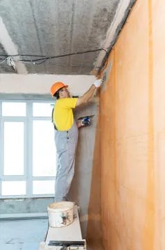 The construction worker putty a wall. Stock Photos