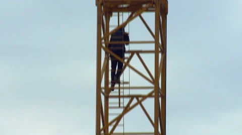 Construction Worker Quickly Getting Down the Ladder. Blue Sky Stock Footage 65419010