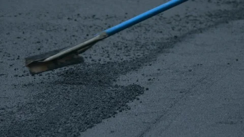 Construction Worker Raking Asphalt, Close Up. Stock Footage 91331606