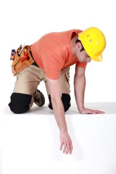 Construction worker reaching down Stock Photos