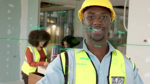 Construction worker reading plans as cam zooming looking up smiling while AR HUD Stock Footage 333220051