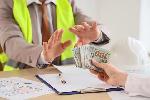 Construction worker refusing bribe money, anti-corruption and ethical busines Stock Photos