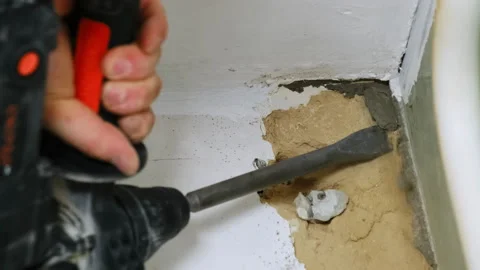 Construction worker removes sections of old wall plaster Stock Footage 304403488