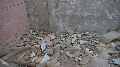 Construction worker removing tiles from bathroom floor Stock Footage 297464721