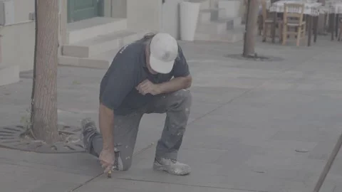 A construction worker repairing the floor in Paphos, Cyprus Stock Footage 344056674