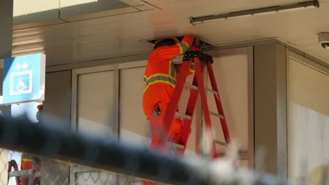 Construction worker repairing transit platform Stock Footage 230923453