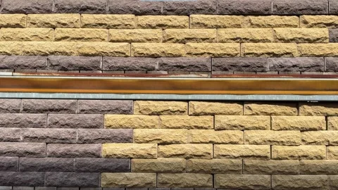 Construction worker repairing a two colored brick wall Stock Footage 314131743