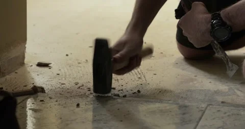 Construction worker replacing tile floor Stock Footage 337976625