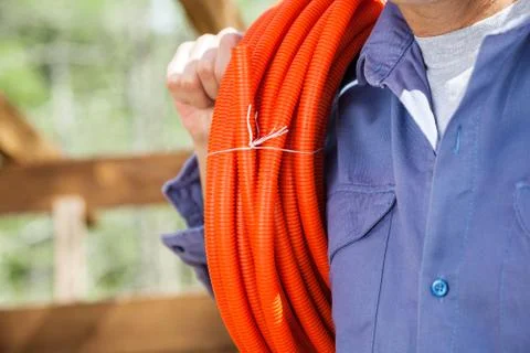 Construction Worker With Rolled Pipe 스톡 사진