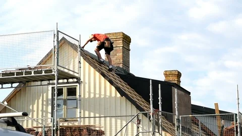 Construction worker on roof Stock Footage 90841174