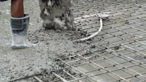 Construction Worker in Rubber Boots Laying Cement Floor Slab Foundation. Stock Footage 337850238