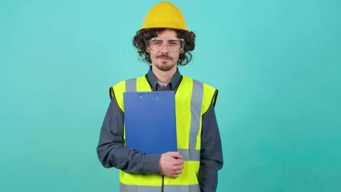 Construction worker with safety glasses and helmet that is looking at camera. 스톡 동영상 151353977