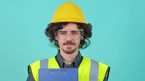 Construction worker with safety glasses and helmet that is looking at camera. Video stock 152725314