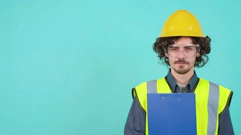 Construction worker with safety glasses and helmet that is looking at camera Stock Footage 155809968