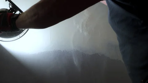 Construction worker is sanding a drywall surface using a sandpaper. Worker Stock Footage 320146949