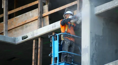 Construction worker sands and polishes the wall at development site Stock Footage 34132871