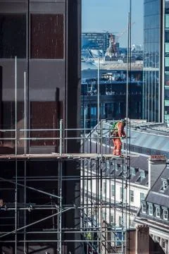 Construction worker on scaffold on a building site in London, UK Fotos de archivo