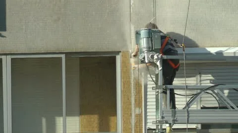 Construction worker on scaffolding repairing the building Stock Footage 8969955