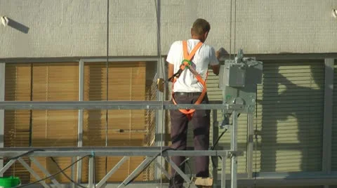 Construction worker on scaffolding repairing the building Stock Footage 8969959