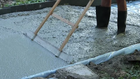 Construction worker screeding wet concrete floor slab Stock-Footage 342702983