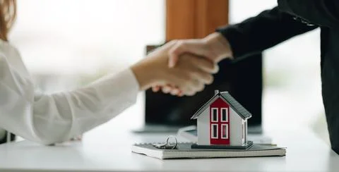 Construction worker shaking hands with customer after finishing up business.. Stock Photos