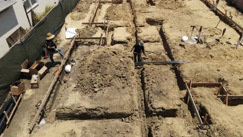 Construction worker shoveling dirt while other man waiting Stock-Footage 228794827