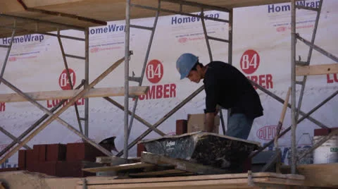 Construction worker shoveling mortar Stock Footage 23115110