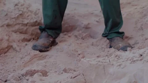 Construction worker shoveling sand for bio construction plaster Stock Footage 342256905