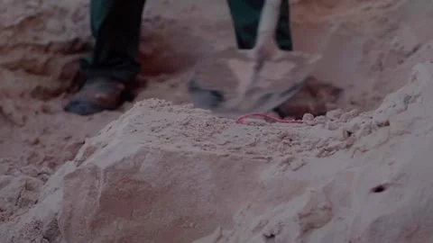 Construction worker shoveling sand on a building site Stock Footage 342256732